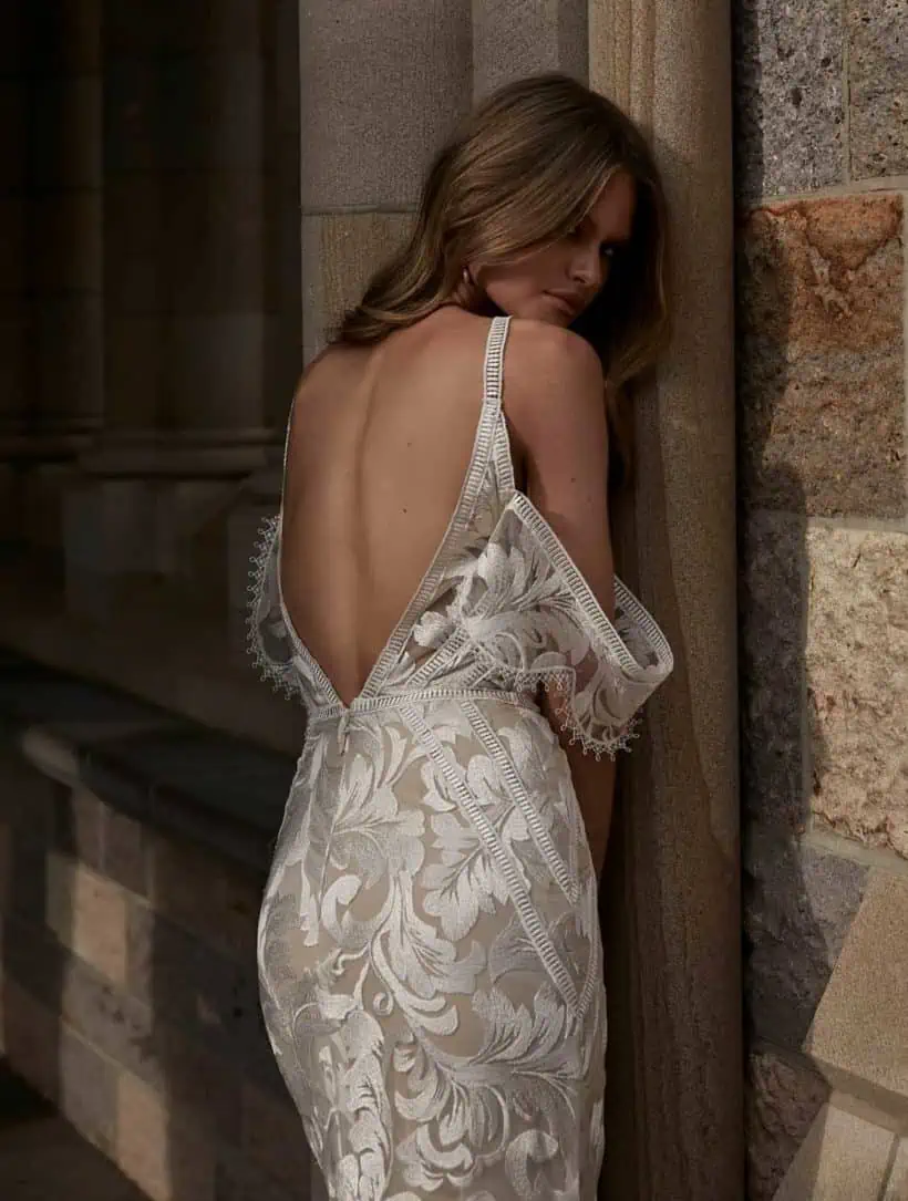 Klasszikusan elegáns, ugyanakkor romantikus sellő fazonú menyasszonyi ruha lecsatolható karpánttal. Az anyaga különleges hímzett virágminták.. Style: Evie Young "Saylor Hátulról, közelről fotózva