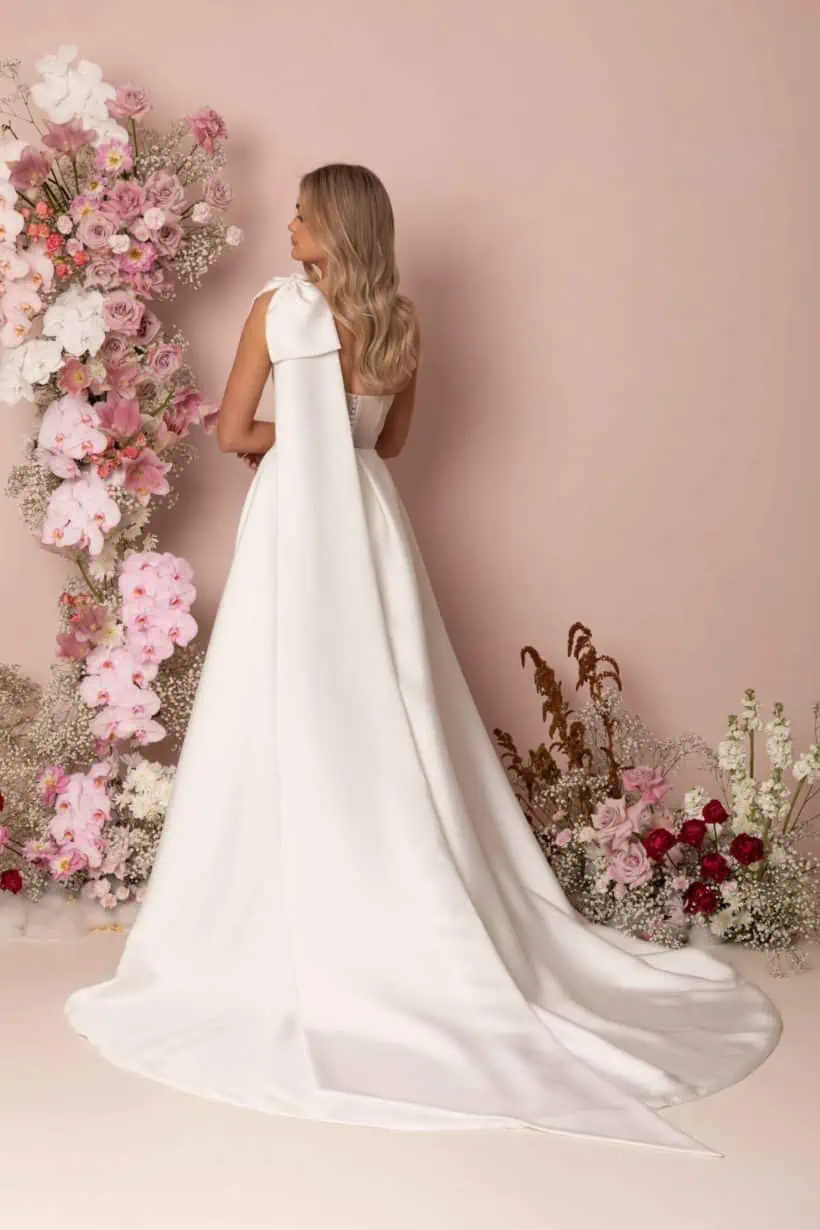 Vagány, modern,, különleges esküvői ruha a Madi Lane kollekcióból. Asszimetrikus, félvállas, A vonalú modell magasan sliccelt szoknyával. Style: Kinsley hátulról